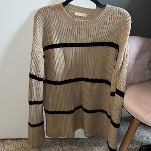 Nude sweater with black stripes